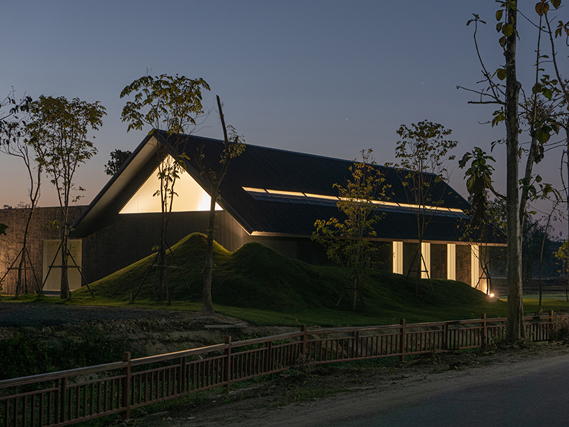 gabled longhouse showroom by sher maker celebrates artisanal woodworking in chiang mai