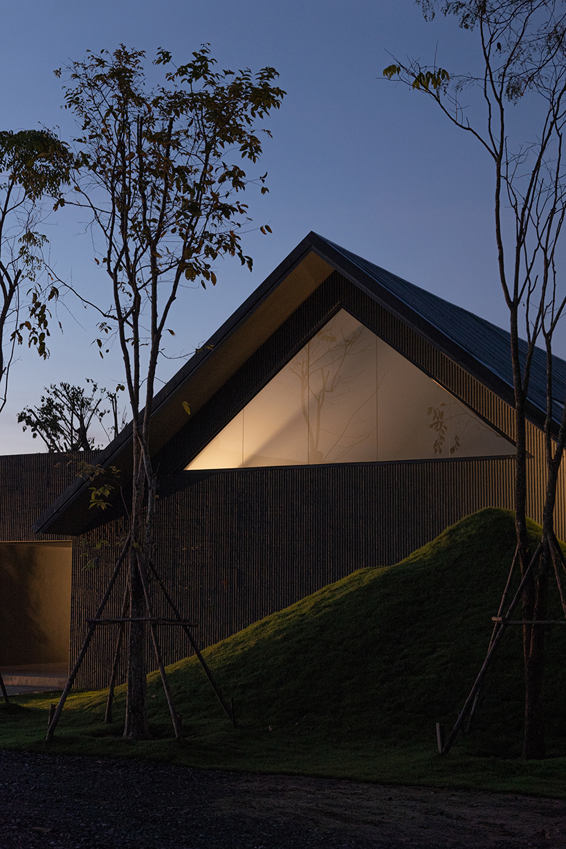 gabled longhouse showroom by sher maker celebrates artisanal woodworking in chiang mai