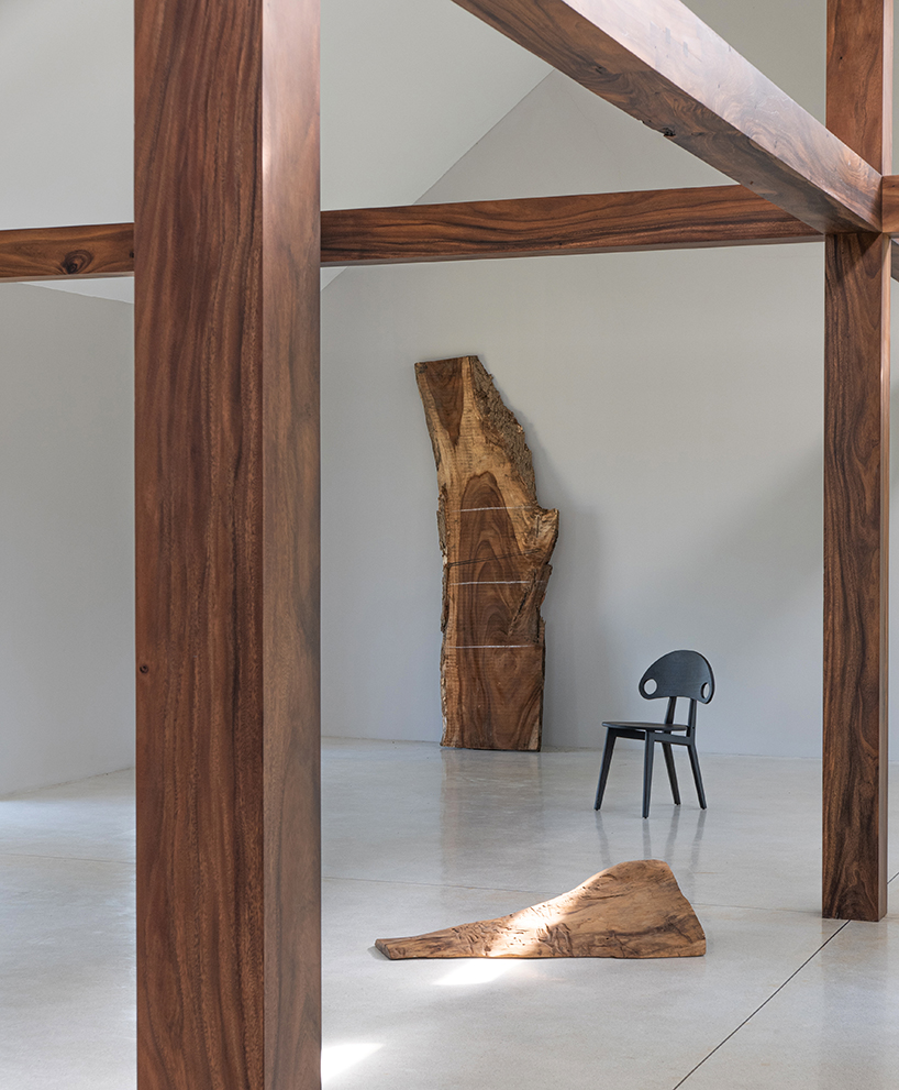 gabled longhouse showroom by sher maker celebrates artisanal woodworking in chiang mai