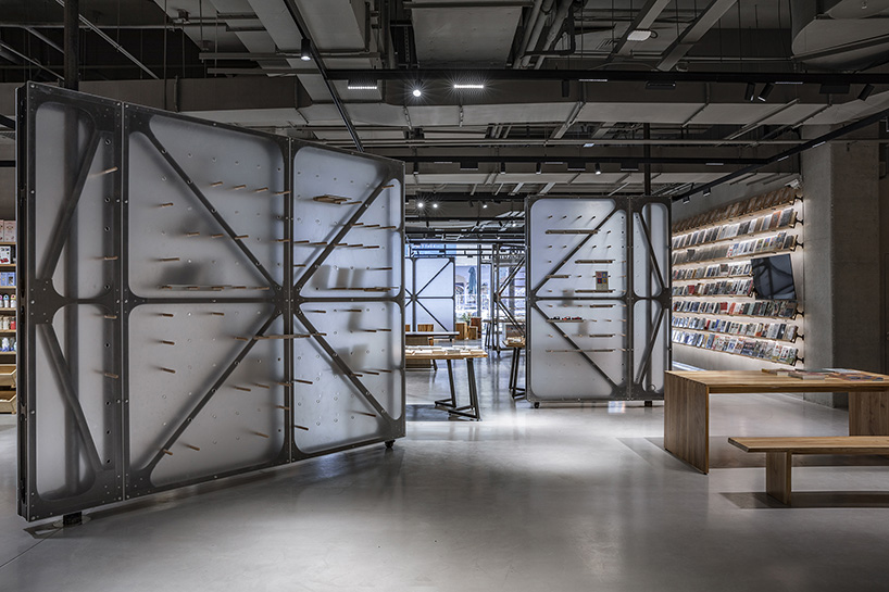 transparent rotating walls + exposed pipes assemble LUO studio's flexible bookstore space