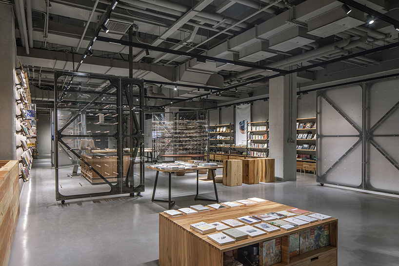 transparent rotating walls + exposed pipes assemble LUO studio's flexible bookstore space