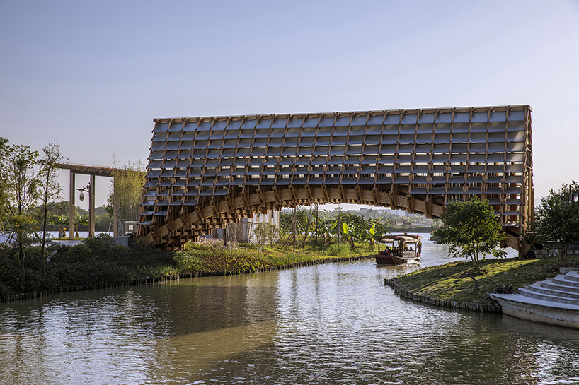 LUO studio extrudes arched timber bridge in china to revitalize traditional rural culture