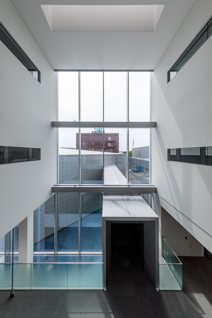 this transparent showroom in japan is surrounded by an artificial pond takenaka designboom