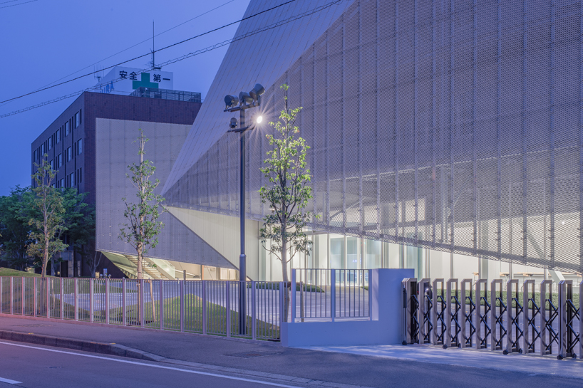 this transparent showroom in japan is surrounded by an artificial pond takenaka designboom