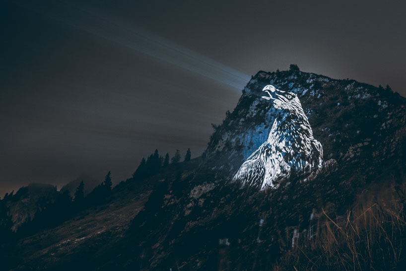 julien nonnon raises awareness by projecting endangered animals onto alpine mountains