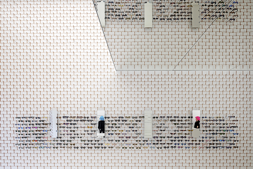 mold architects installs a metal curtain wall to display sunglasses in athens eyewear store designboom