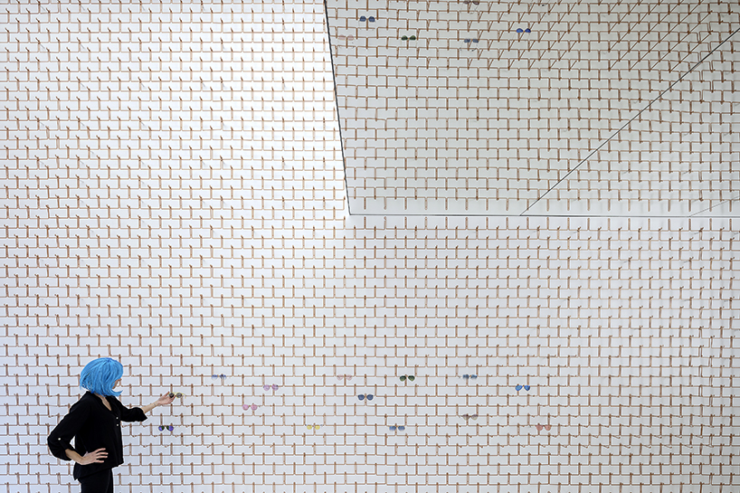 mold architects installs a metal curtain wall to display sunglasses in athens eyewear store designboom