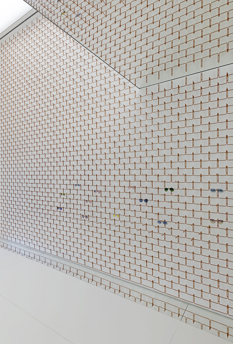 mold architects installs a metal curtain wall to display sunglasses in athens eyewear store designboom