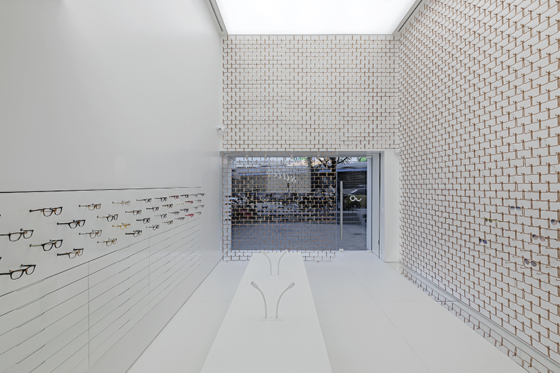 mold architects installs a metal curtain wall to display sunglasses in athens eyewear store designboom