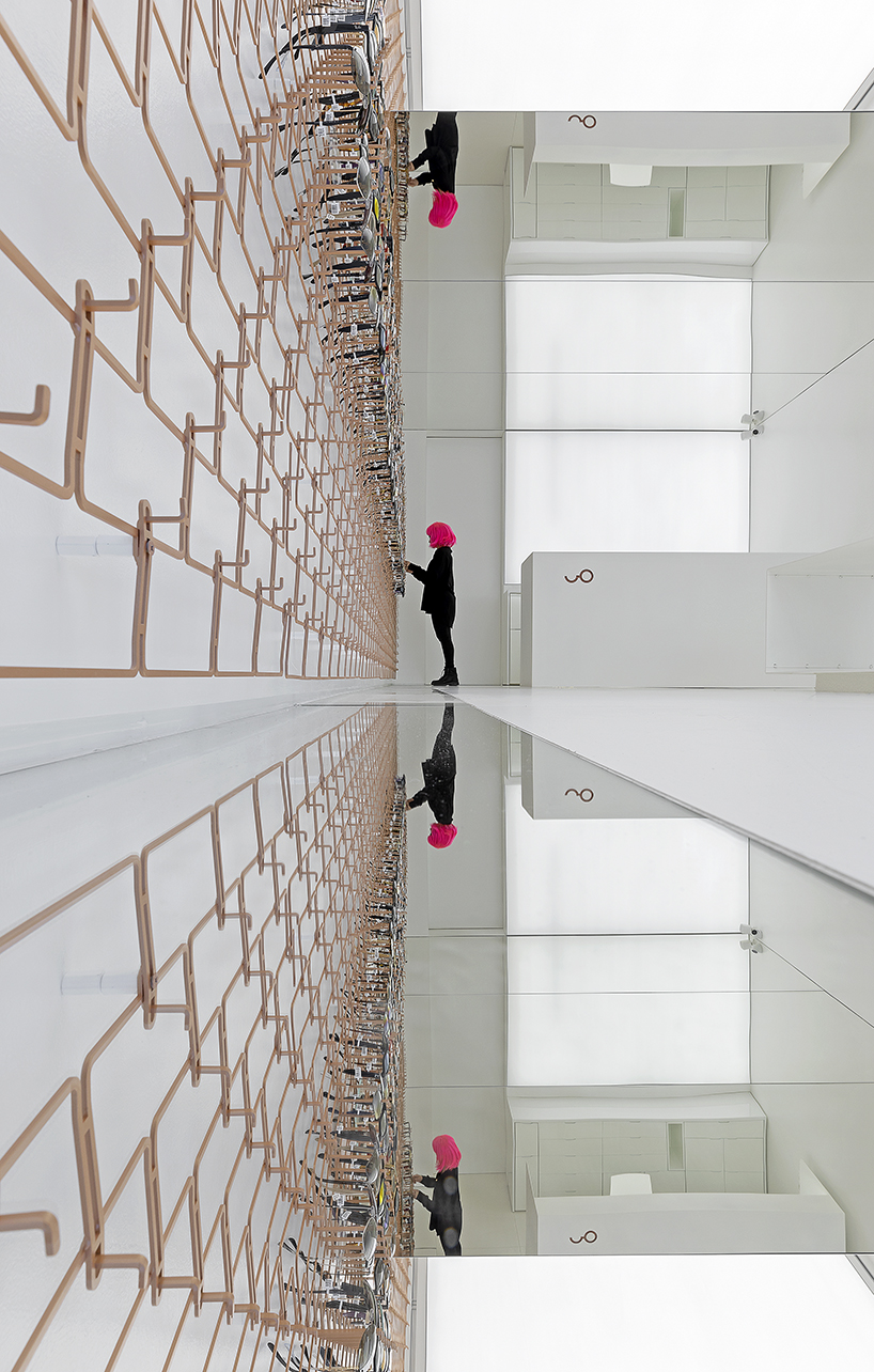 mold architects installs a metal curtain wall to display sunglasses in athens eyewear store designboom