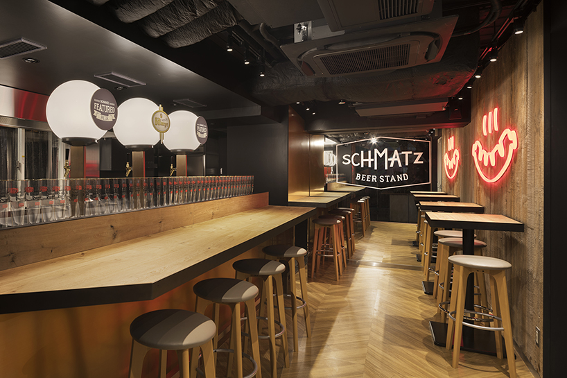 I IN repurposes a shipping container to form the SCHMATZ beer stand in tokyo designboom