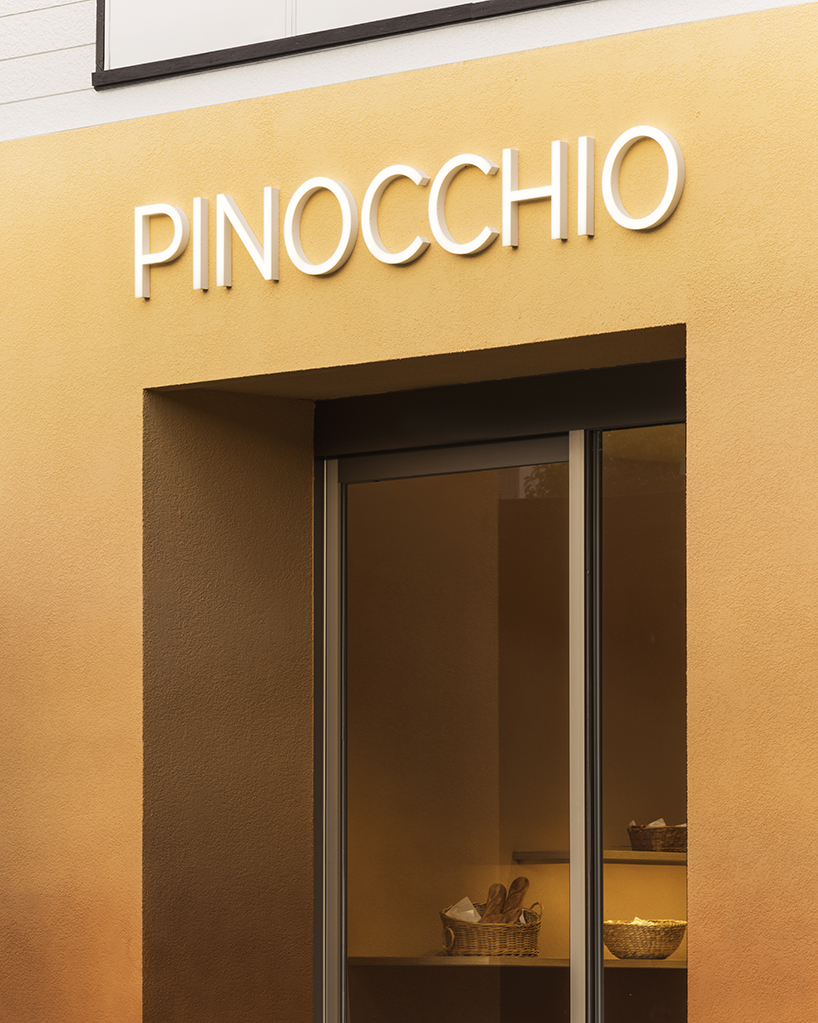 the color of baked bread adorns the façade of I IN's pinocchio bakery in japan designboom