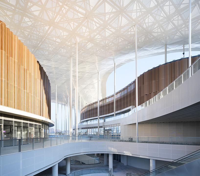 cloud-like winged roof floats above UAD's asian games sports cultural center in hangzhou