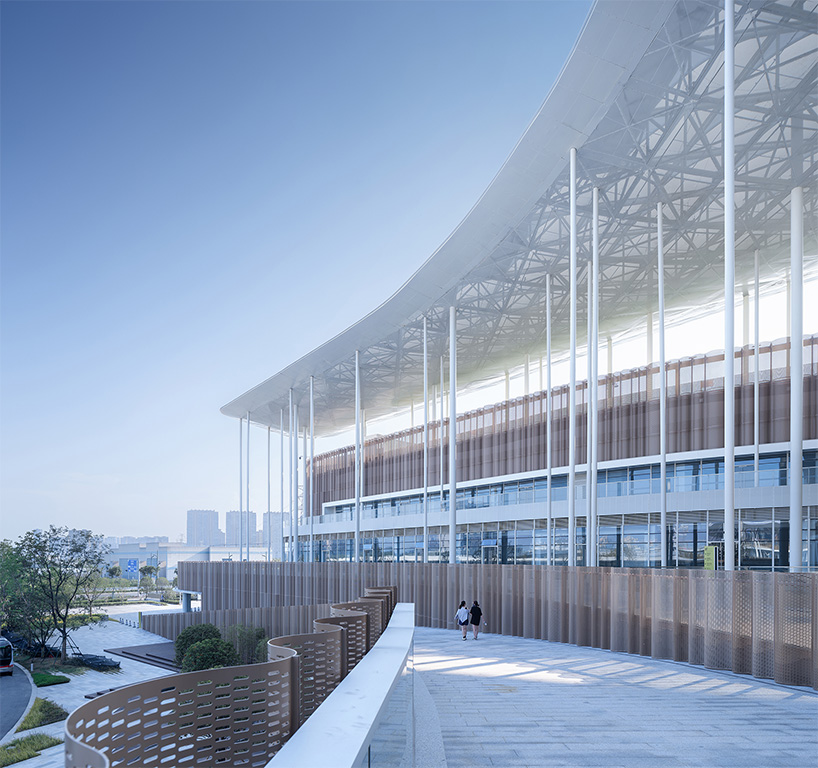cloud-like winged roof floats above UAD's asian games sports cultural center in hangzhou