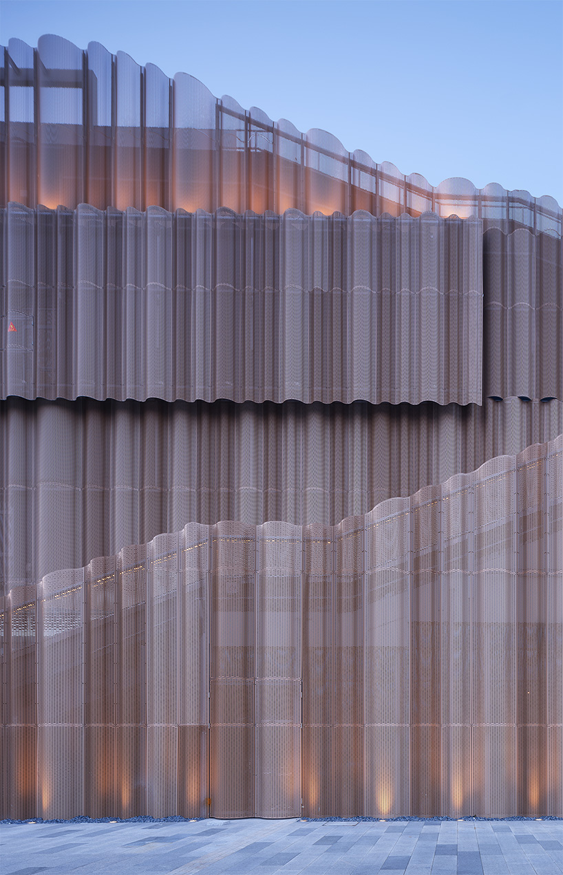 cloud-like winged roof floats above UAD's asian games sports cultural center in hangzhou