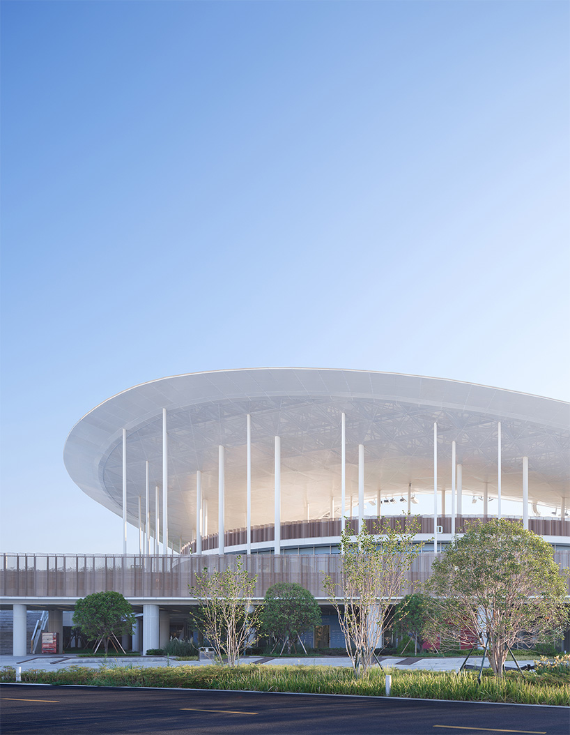 cloud-like winged roof floats above UAD's asian games sports cultural center in hangzhou