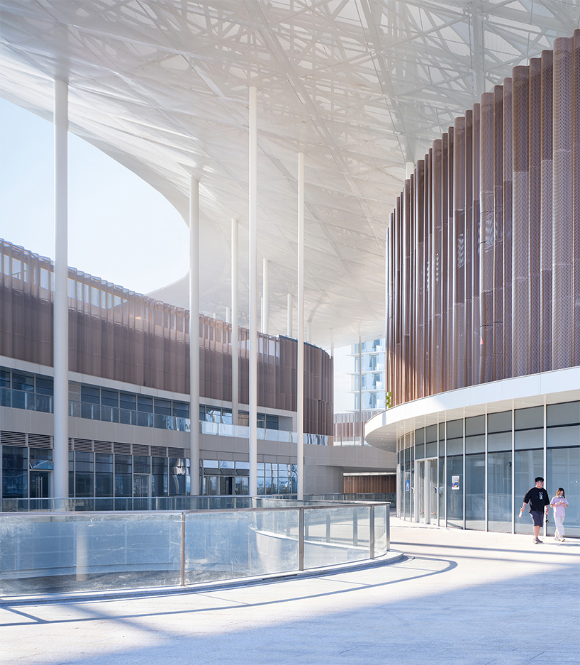 cloud-like winged roof floats above UAD's asian games sports cultural center in hangzhou