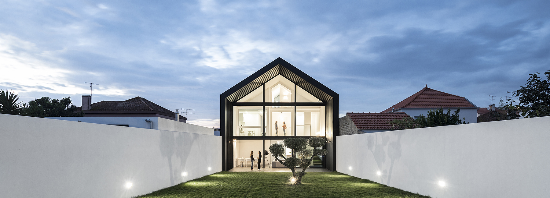 maria fradinho articulates the arch house with large gable roof in portugal
