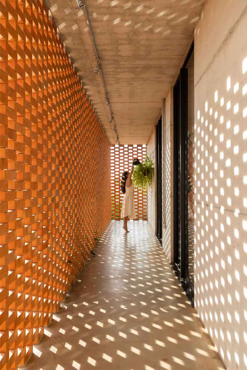 perforated brick facade punctuates fernanda padula’s concrete house in brazil