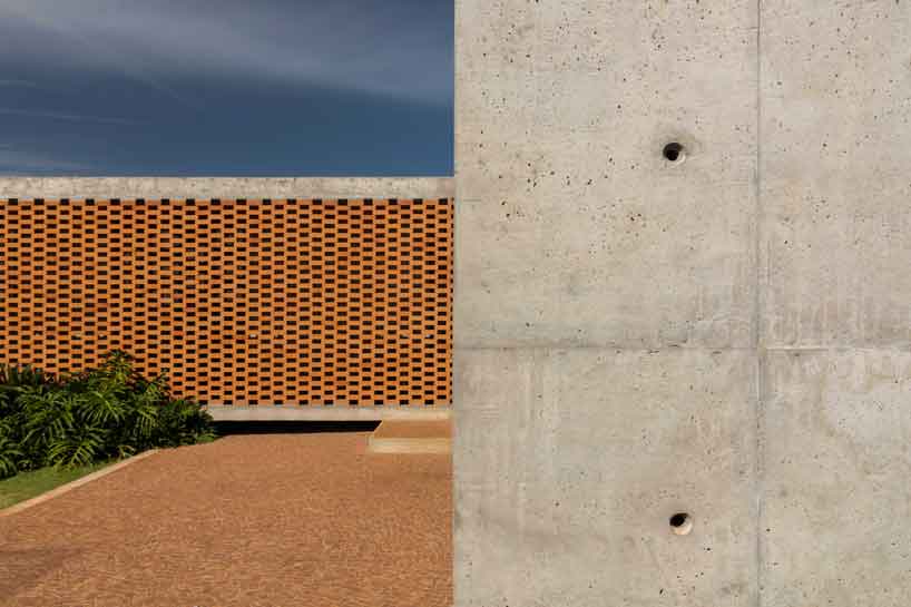perforated brick facade punctuates fernanda padula’s concrete house in brazil