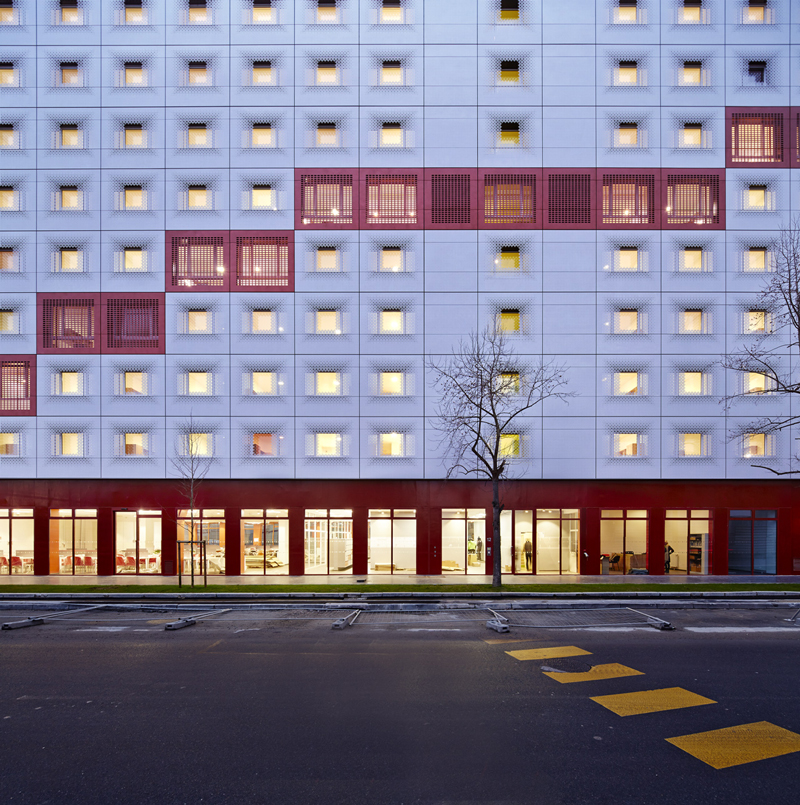 white & bright red perforated metal facade clads student housing by BFV in france