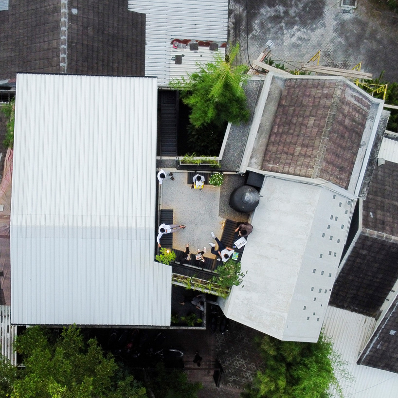 bamboo 'breathing walls' draw natural light in andyrahman's biophilic workspace in indonesia