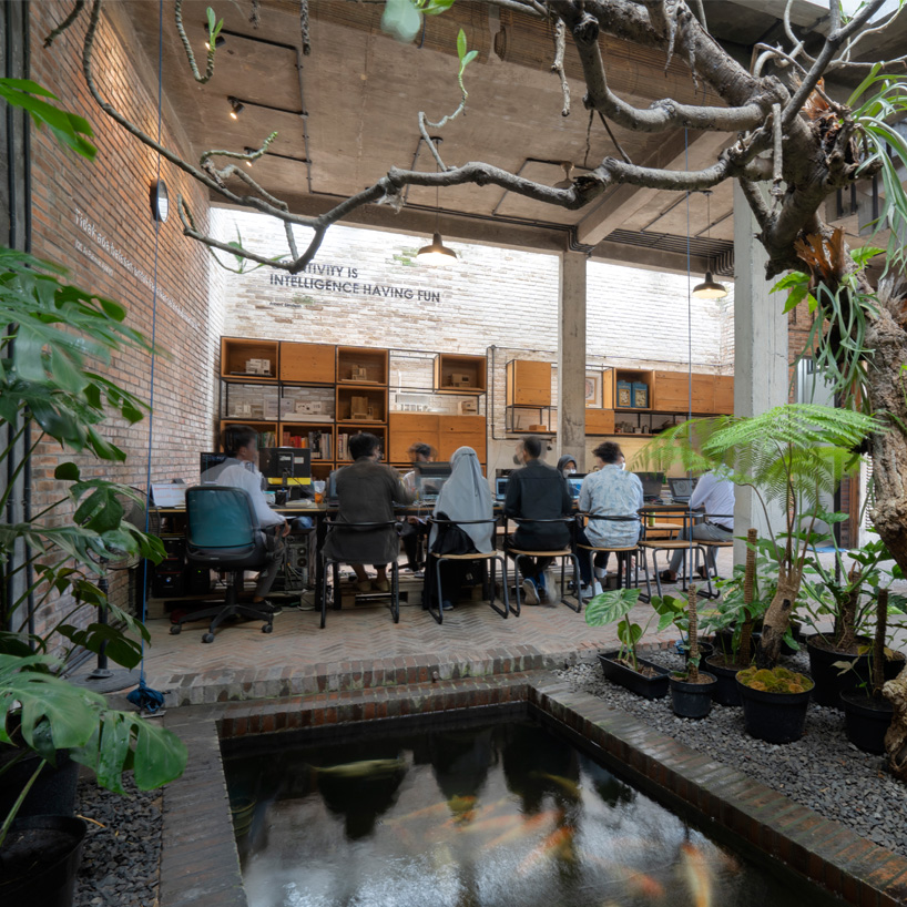 bamboo 'breathing walls' draw natural light in andyrahman's biophilic workspace in indonesia