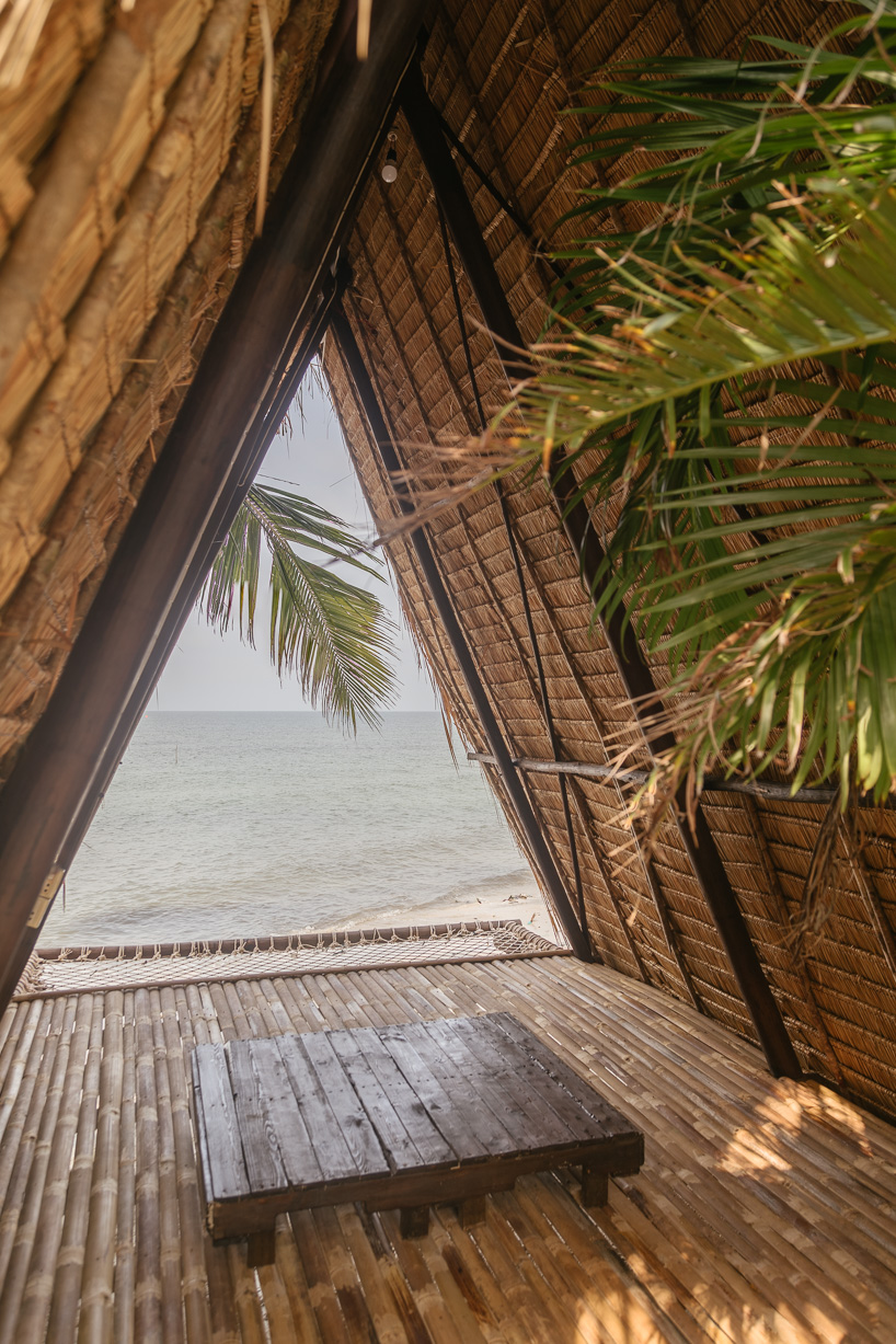 estudio cavernas builds a beach getaway using bettle nut palm trunks and bamboo on the shores of cambodia 5