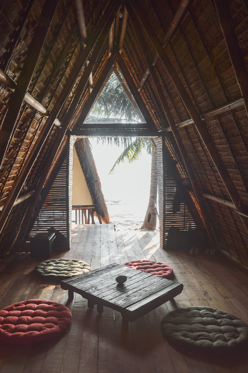 estudio cavernas builds a beach getaway using bettle nut palm trunks and bamboo on the shores of cambodia 8
