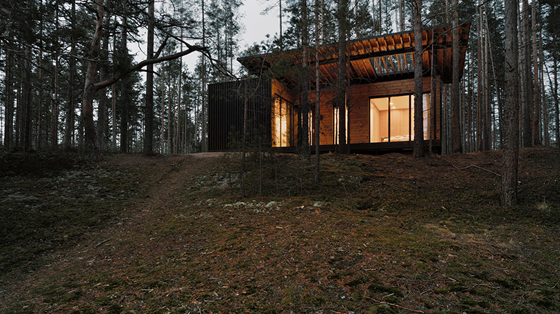 prefab cabin hotel by rhizome settles isolated within karelian landscape, in russia