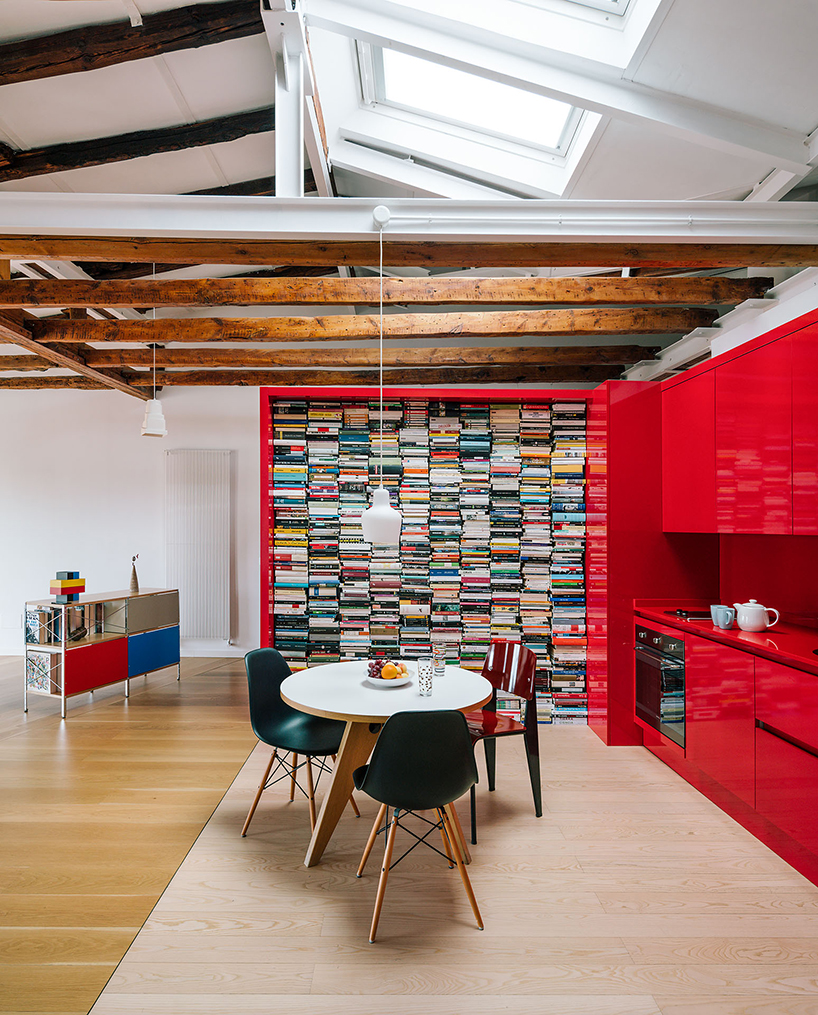 gon architects inserts a bright red, continuous furniture to articulate attic in madrid