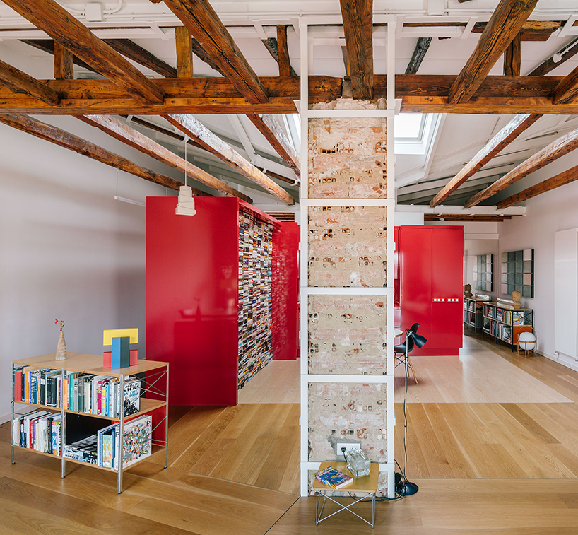gon architects inserts a bright red, continuous furniture to articulate attic in madrid