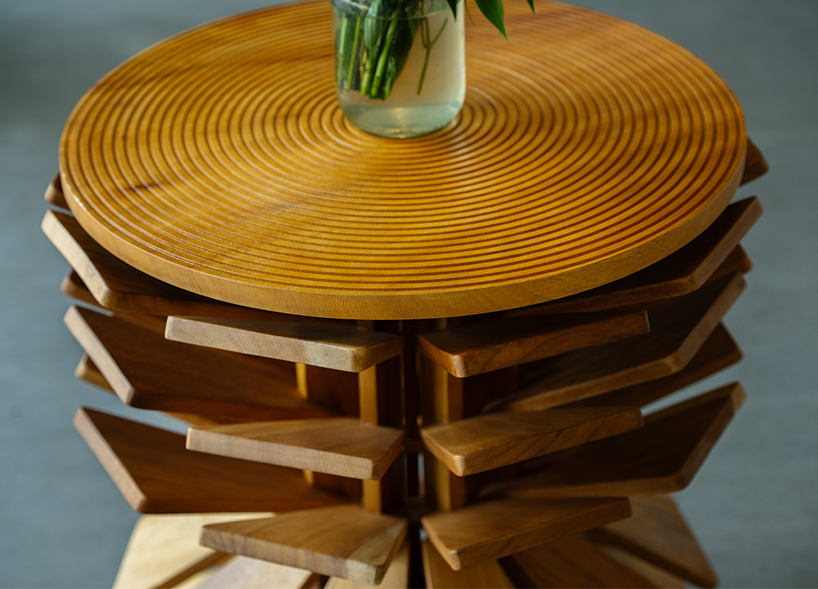 salù iwadi studio layers spiraling wooden fins to form zangbeto side table - 2