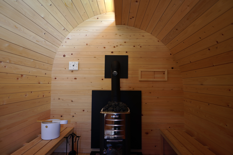 thinned trees from japanese forest compose kairi eguchi studio's barrel-shaped sauna with stepped ceiling