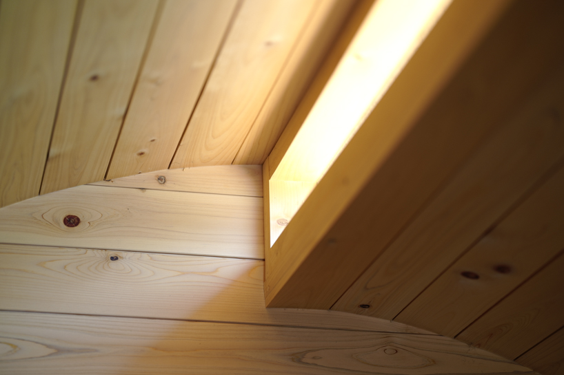 thinned trees from japanese forest compose kairi eguchi studio's barrel-shaped sauna with stepped ceiling