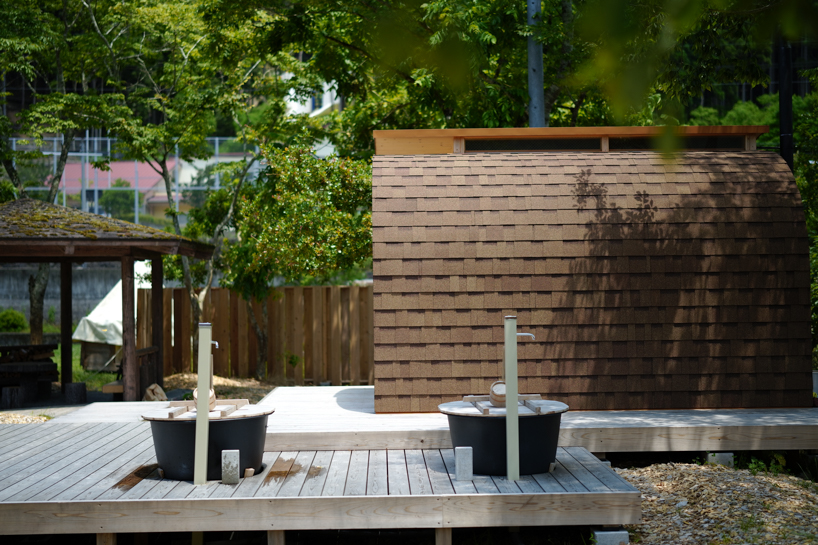 thinned trees from japanese forest compose kairi eguchi studio's barrel-shaped sauna with stepped ceiling