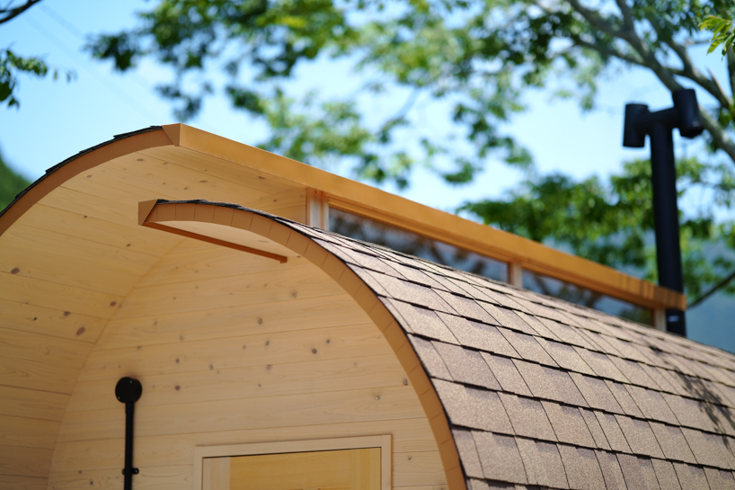 thinned trees from japanese forest compose kairi eguchi studio's barrel-shaped sauna with stepped ceiling