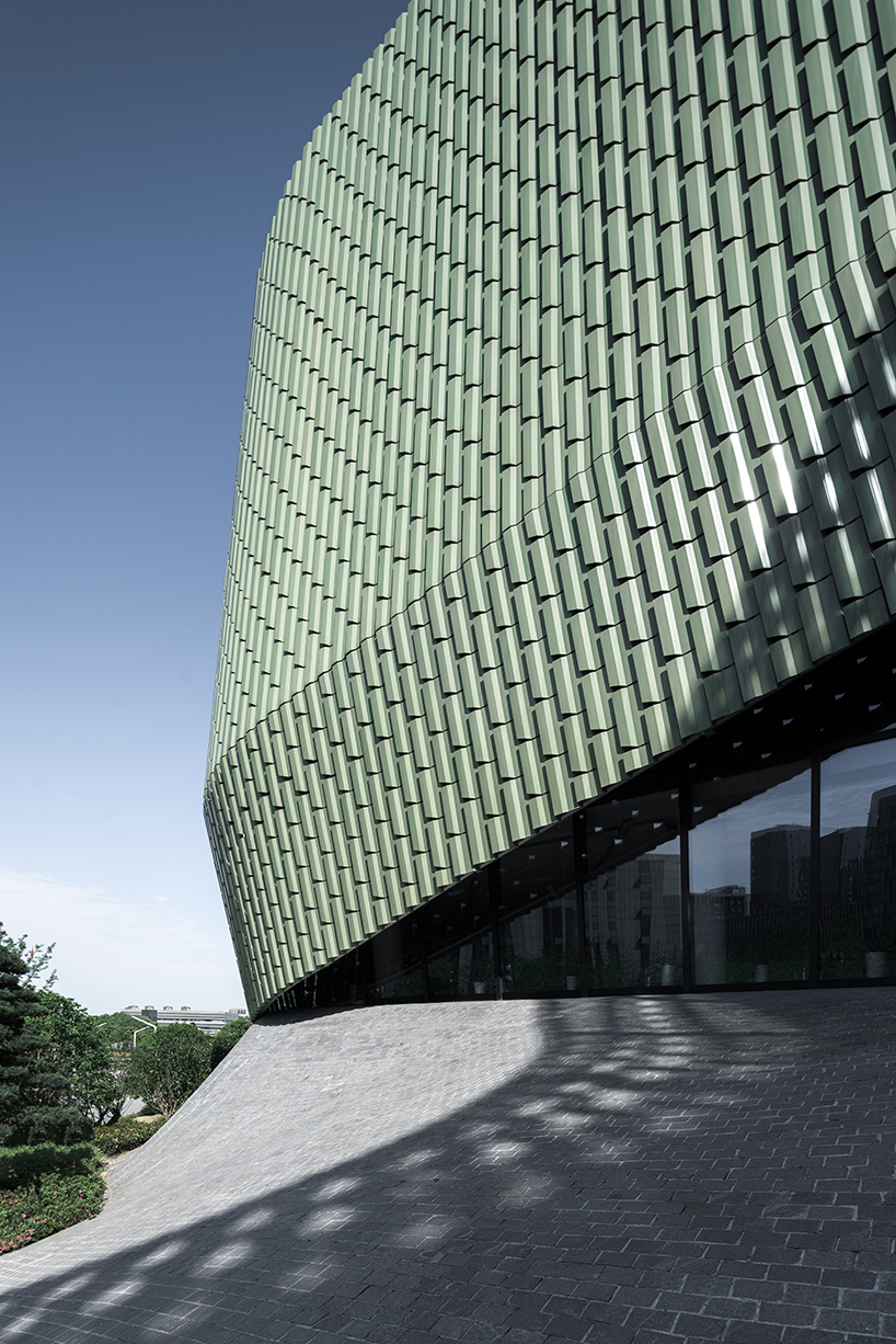 a textured ceramic skin clads playze + schmidhuber's exhibition center in china designboom