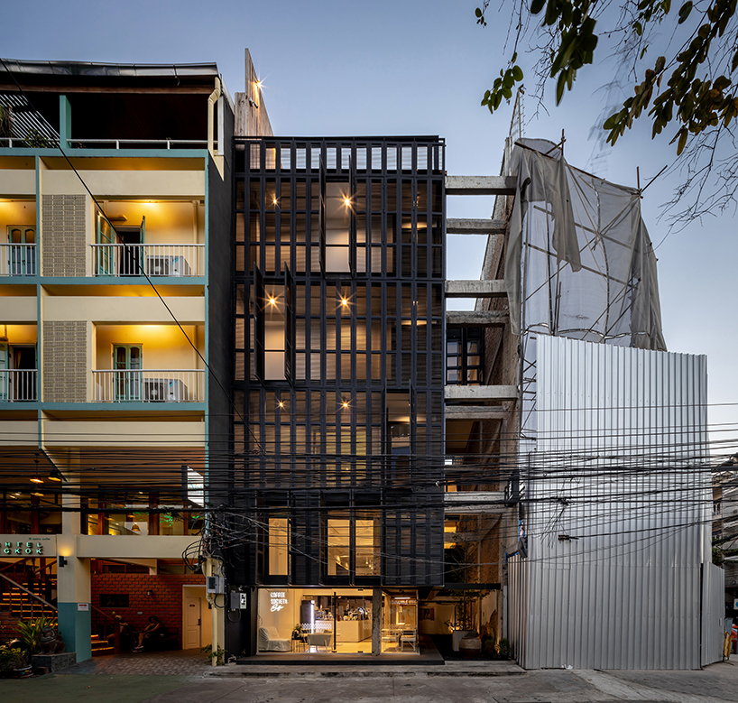 IDIN architects completes pa prank hostel in bangkok with façade of black shutters