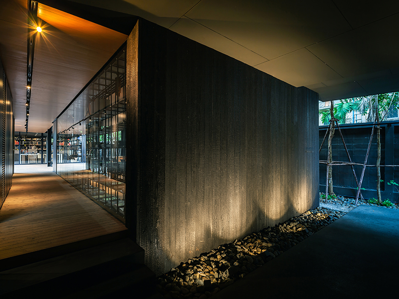 black timber cladding envelops IDIN architects' tranquil office space in bangkok designboom