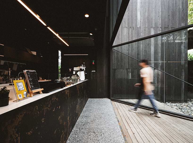 black timber cladding envelops IDIN architects' tranquil office space in bangkok designboom