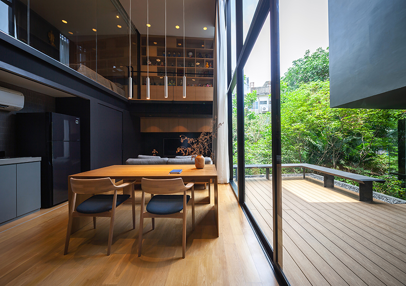 black timber cladding envelops IDIN architects' tranquil office space in bangkok designboom