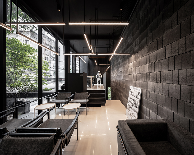 black timber cladding envelops IDIN architects' tranquil office space in bangkok designboom