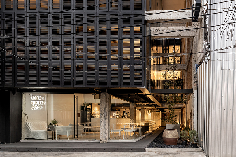 IDIN architects completes pa prank hostel in bangkok with façade of black shutters