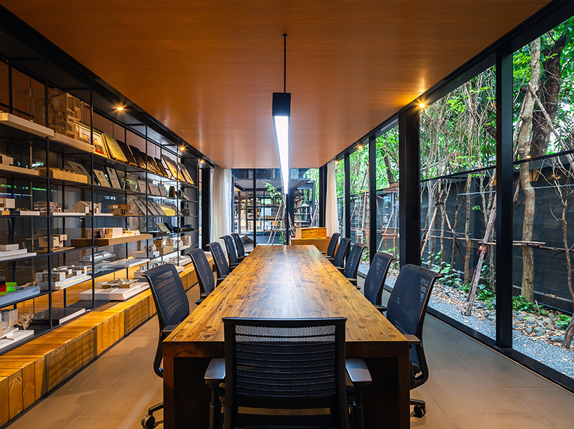 black timber cladding envelops IDIN architects' tranquil office space in bangkok designboom