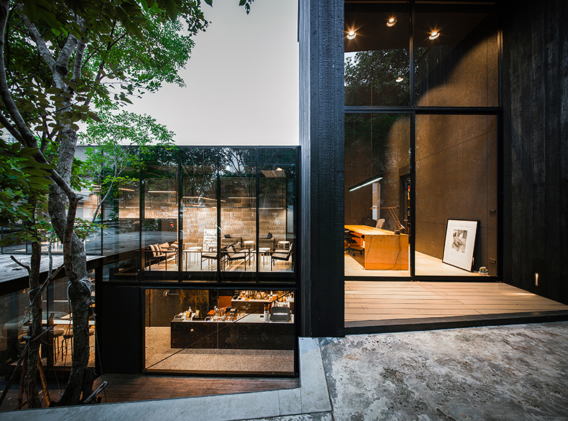 black timber cladding envelops IDIN architects' tranquil office space in bangkok designboom