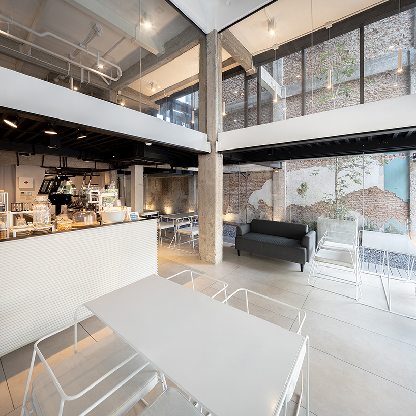 IDIN architects completes pa prank hostel in bangkok with façade of black shutters