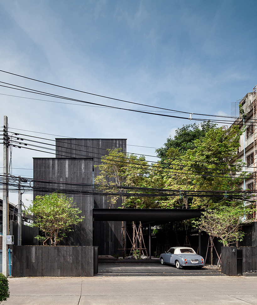 black timber cladding envelops IDIN architects' tranquil office space in bangkok designboom