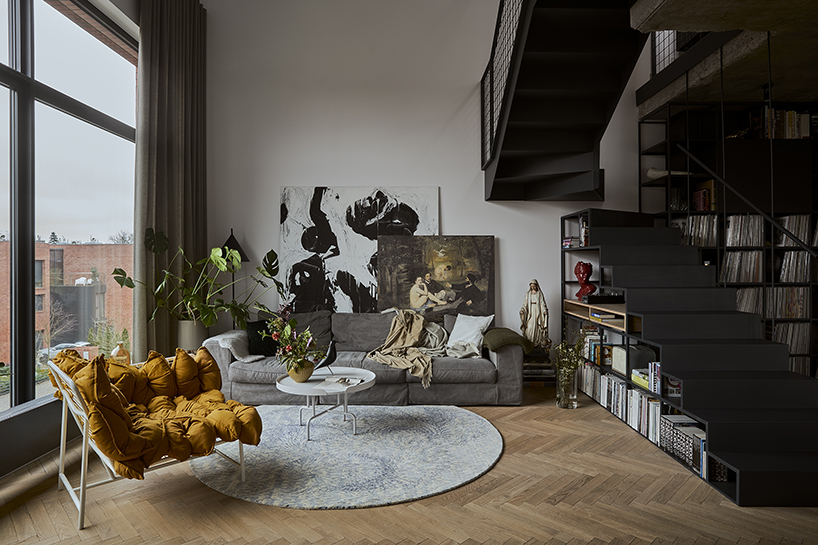 a steel staircase doubles as storage in this poznan apartment, designed by UGO designboom