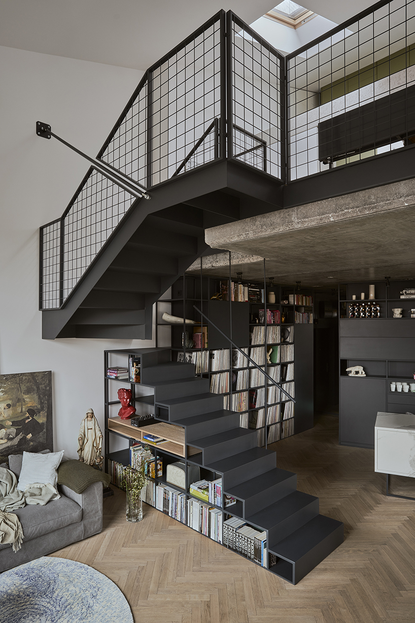 a steel staircase doubles as storage in this poznan apartment, designed by UGO designboom